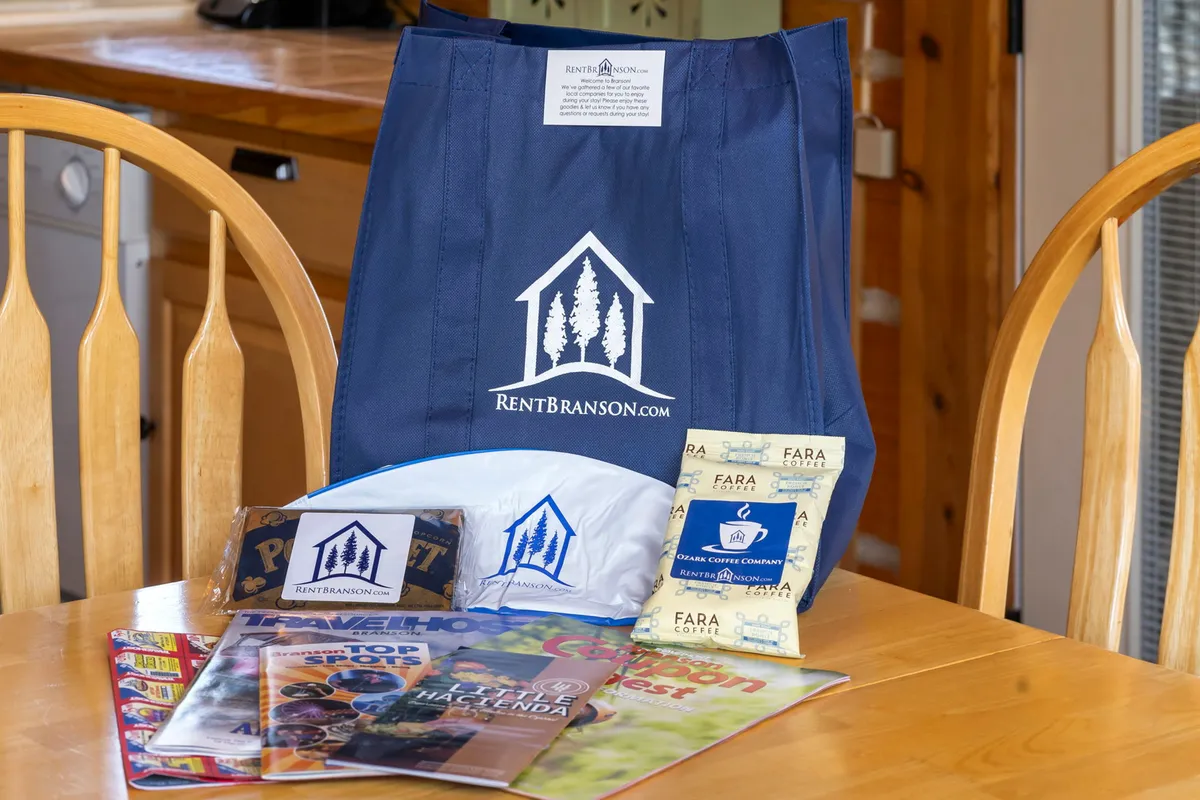 A blue tote bag is set on a surface next to a selection of magazines and coffee samples, suggesting preparation for a day of local exploration. The scene feels cozy and welcoming, with an undercurrent of anticipation for nearby activities.